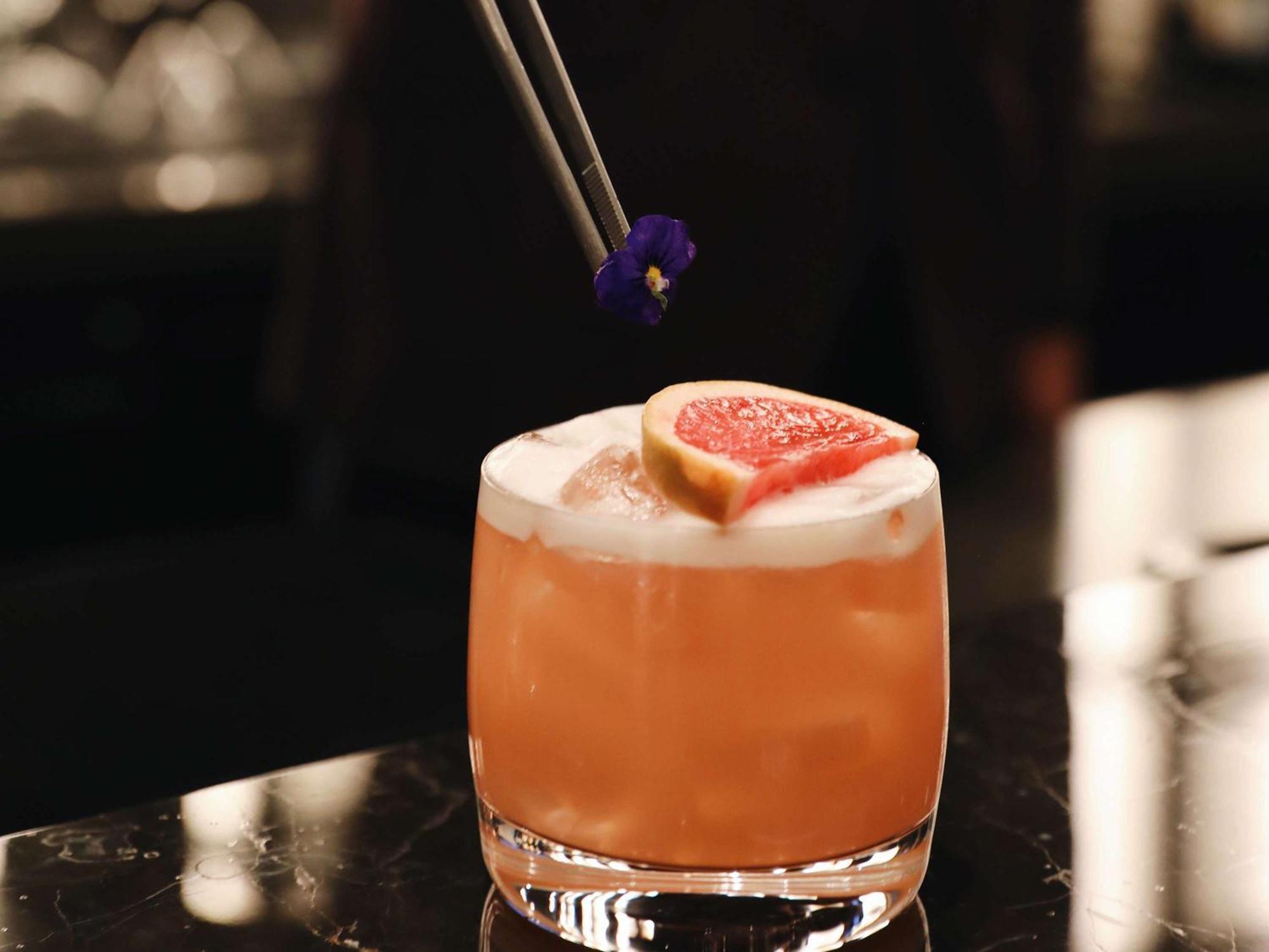 Hotel Sofitel Istanbul Taksim Zewnętrze zdjęcie A cocktail being garnished with edible flowers